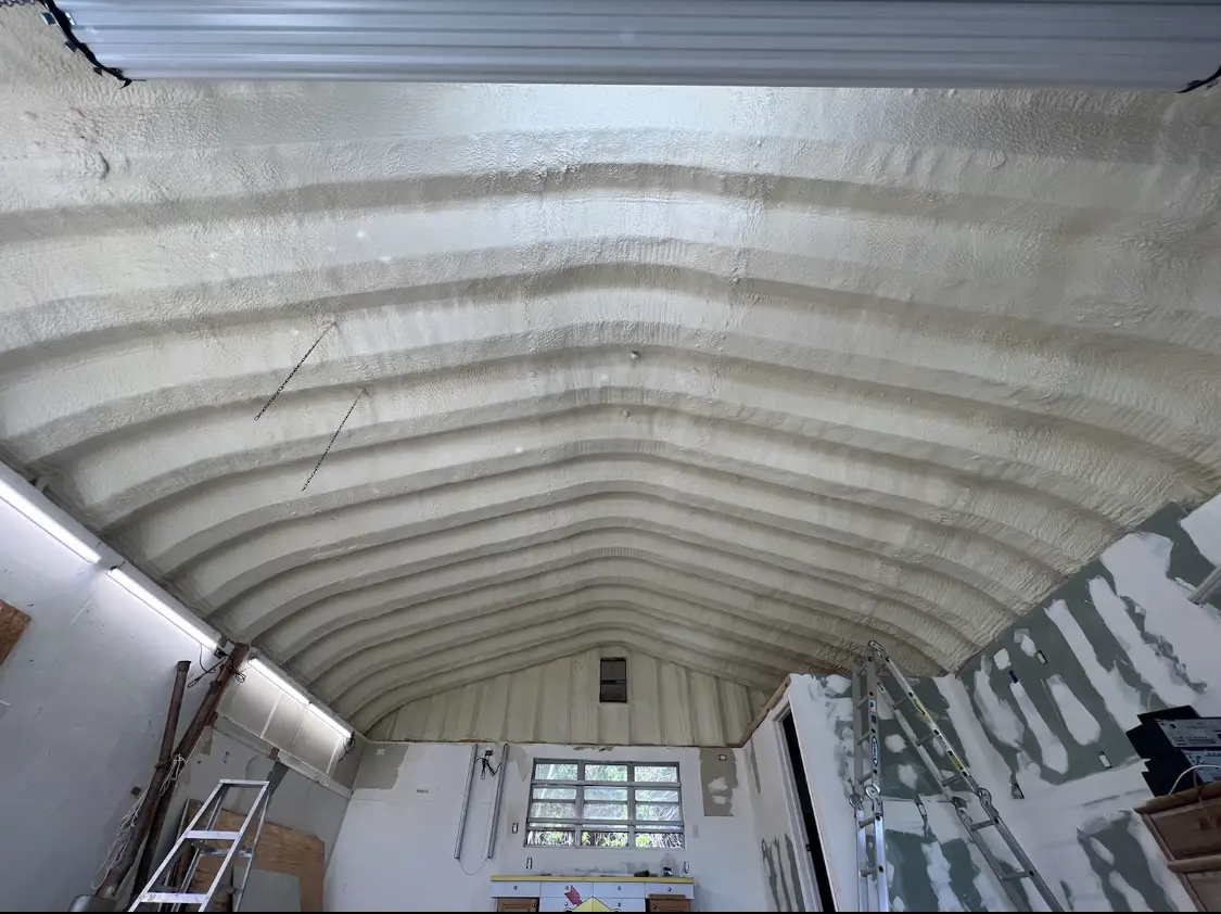 Spray polyurethane foam applied to the underside of a metal roof deck in Hyde Park